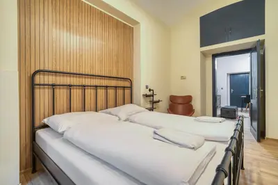 a row of beds in a room at KYRA Apartments by Rentez in Prague