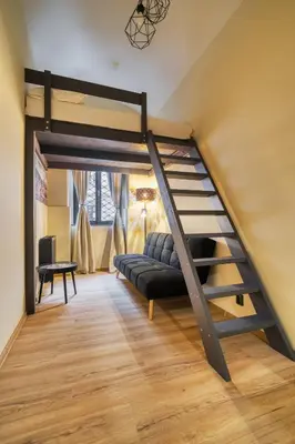 a living room with a loft bed and a couch at KYRA Apartments by Rentez in Prague