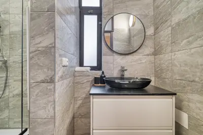 a bathroom with a sink and a mirror at KYRA Apartments by Rentez in Prague
