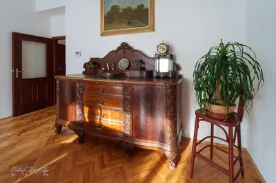 a kitchen with white cabinets and a counter top at First Republic Apartment Strahov in Prague