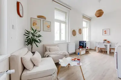 a living room with a bed and a kitchen at Jane's Cozy Corner Studio in Prague