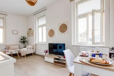 a bedroom with a bed and a living room at Jane's Cozy Corner Studio in Prague