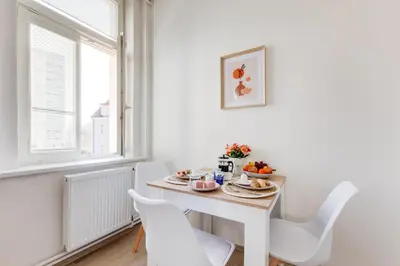 a bedroom with a large bed with two towels on it at Jane's Cozy Corner Studio in Prague
