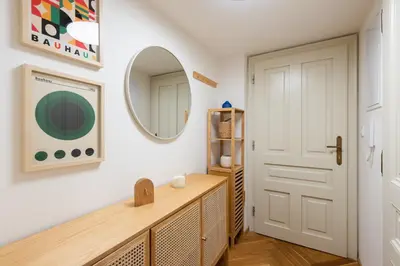 a dressing room with a mirror and a wooden dresser at Little Oasis in Prague