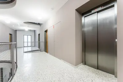 a hallway with elevators in a building at Rentero NEW Anděl Skyline Apartment - Prague 5 in Prague