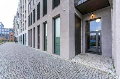 an empty street in front of a building at Rentero NEW Anděl Skyline Apartment - Prague 5 in Prague
