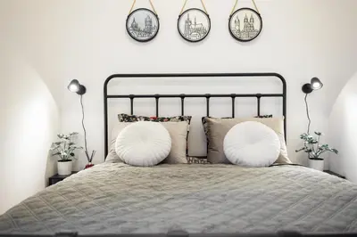 a bedroom with a large bed with two white pillows at Rotunda Residence - with free weekend parking in Prague