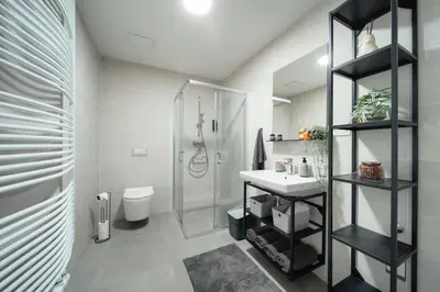 a bathroom with a shower toilet and a sink at Rotunda Residence - with free weekend parking in Prague