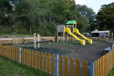 a playground with a yellow slide in a park at Rotunda Residence - with free weekend parking in Prague