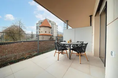 a patio with a table and chairs on a balcony at Rotunda Residence - with free weekend parking in Prague