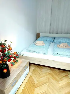 a bedroom with a bed and a vase with a plant at Sophia apartment in Prague