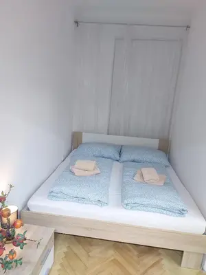 a bed with two pillows on it in a room at Sophia apartment in Prague