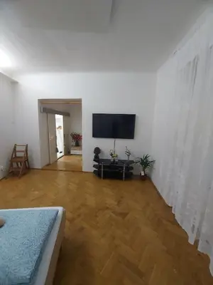 a living room with a flat screen tv on a white wall at Sophia apartment in Prague