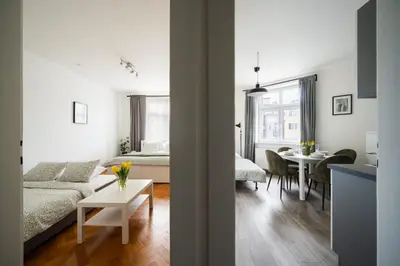 a bedroom with a large bed in front of a window at Cozy One-Bedroom Apartment by Flora Metro Station in Prague