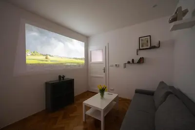 a white bed with white pillows and a window at Cozy One-Bedroom Apartment by Flora Metro Station in Prague