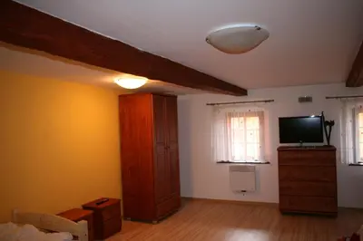 a living room with a television and a dresser with a tvicterictericter at Podřipská Farma in Roudnice nad Labem