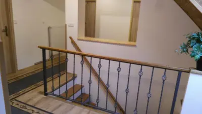 a staircase in a house with a mirror on the wall at Podřipská Farma in Roudnice nad Labem