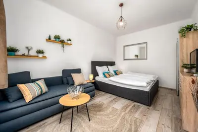 a living room with a couch and a bed at Serenity Suite Prague in Prague