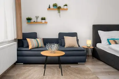 a living room with a couch and a table at Serenity Suite Prague in Prague