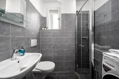 a bathroom with a sink and a toilet and a shower at Serenity Suite Prague in Prague