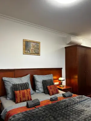a bedroom with a large bed with pillows at Balbinova Grand Apartment Private Balcony in Prague
