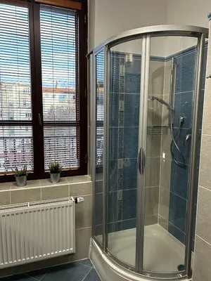a bathroom with a shower with a glass shower stall at Balbinova Grand Apartment Private Balcony in Prague