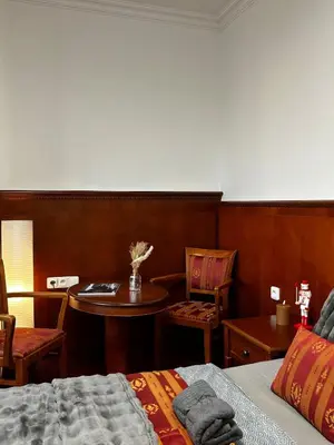 a bedroom with a table and chairs and a bed at Balbinova Grand Apartment Private Balcony in Prague