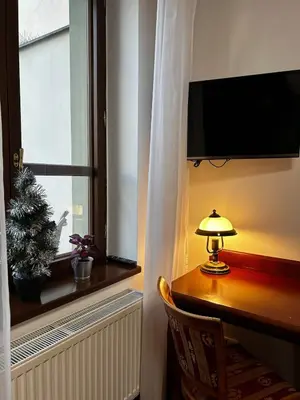 a room with a desk with a lamp and a window at Balbinova Grand Apartment Private Balcony in Prague