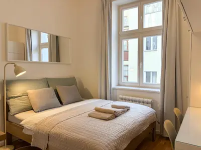 a bedroom with a bed with two towels on it at Museum Park Apartment II in Prague