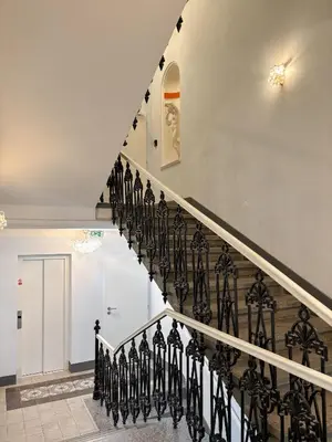 a staircase in a house with black railings at Museum Park Apartment II in Prague