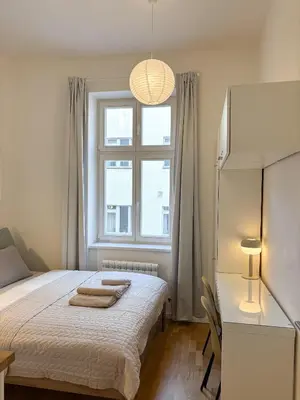 a bedroom with a bed with two towels on it at Museum Park Apartment II in Prague