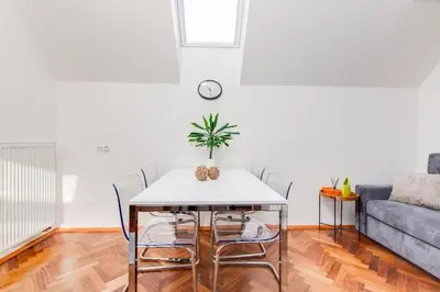 a living room with a table and a couch at Rooftop Apartment, Vinohrady, City Center in Prague