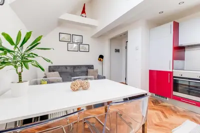 a kitchen with a white counter top in a room at Rooftop Apartment, Vinohrady, City Center in Prague