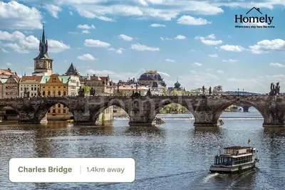 a bridge over a river with a boat at HOMELY I 32m2 Central loft I ELEVATOR I SELF CHECK-IN in Prague