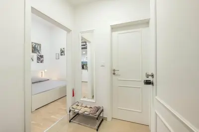 a room with a door and a bed and a mirror at HOMELY I 32m2 Central loft I ELEVATOR I SELF CHECK-IN in Prague