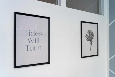two framed pictures on a wall with the words tiles will turn at Crown Tiger Penthouse in Prague