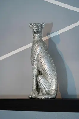 a silver snake statue sitting on a shelf at Crown Tiger Penthouse in Prague