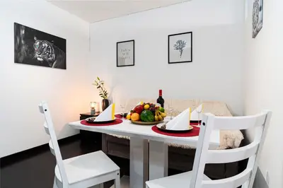 a dining room table with a bowl of fruit on it at Crown Tiger Penthouse in Prague