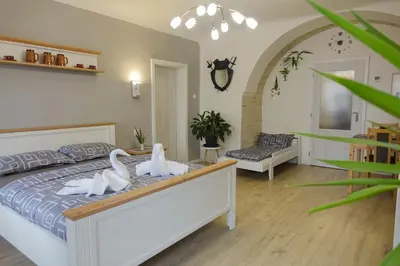 a bedroom with a bed with swans on it at Apartmán U Černého Beránka in Prague