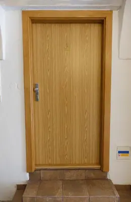 a wooden door in the corner of a room at Apartmán U Černého Beránka in Prague