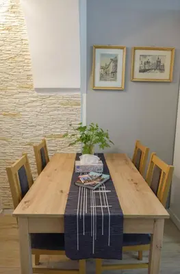 a wooden table with chairs and a plant on it at Apartmán U Černého Beránka in Prague