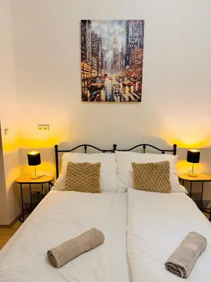 a bedroom with two white beds with two lamps at Zitna Downtown Residence in Prague