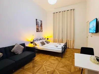 a living room with a bed and a couch at Zitna Downtown Residence in Prague