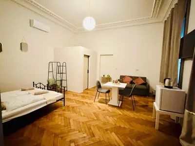 a room with a bed and a table and a couch at Zitna Downtown Residence in Prague