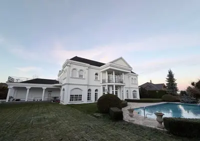 a large white house with a swimming pool at Luxury Villa
