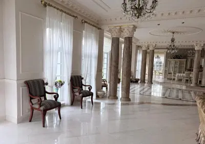 a large room with two chairs and a chandelier at Luxury Villa