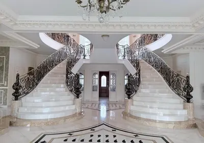 a large staircase in a building with a chandelier at Luxury Villa
