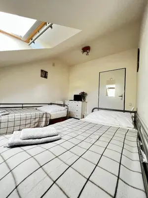 an empty room with two beds and a mirror at Penzion Sofi in Prague