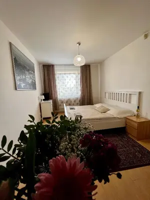 a bedroom with a bed and flowers in the foreground at Penzion Sofi in Prague