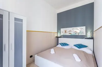 a bedroom with a white bed with blue walls at Legerova 33 Apartments in Prague